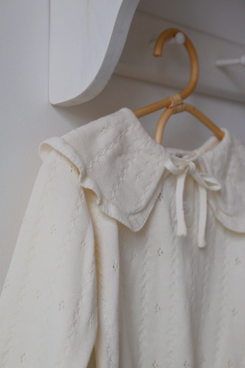 Ivory Pointelle Jumper hung ona bamboo coat hangers