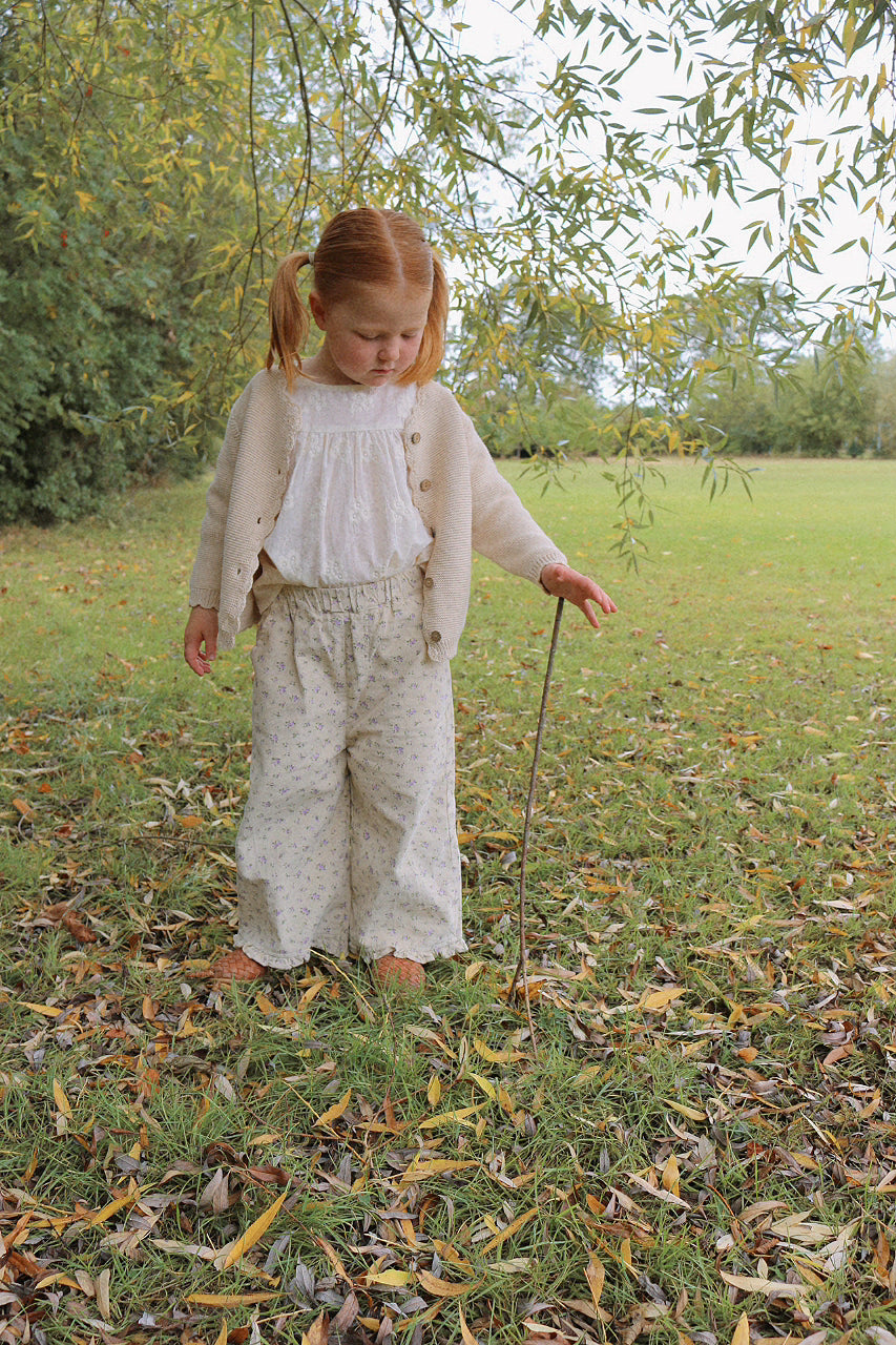 Child in a natural setting with trees and grass