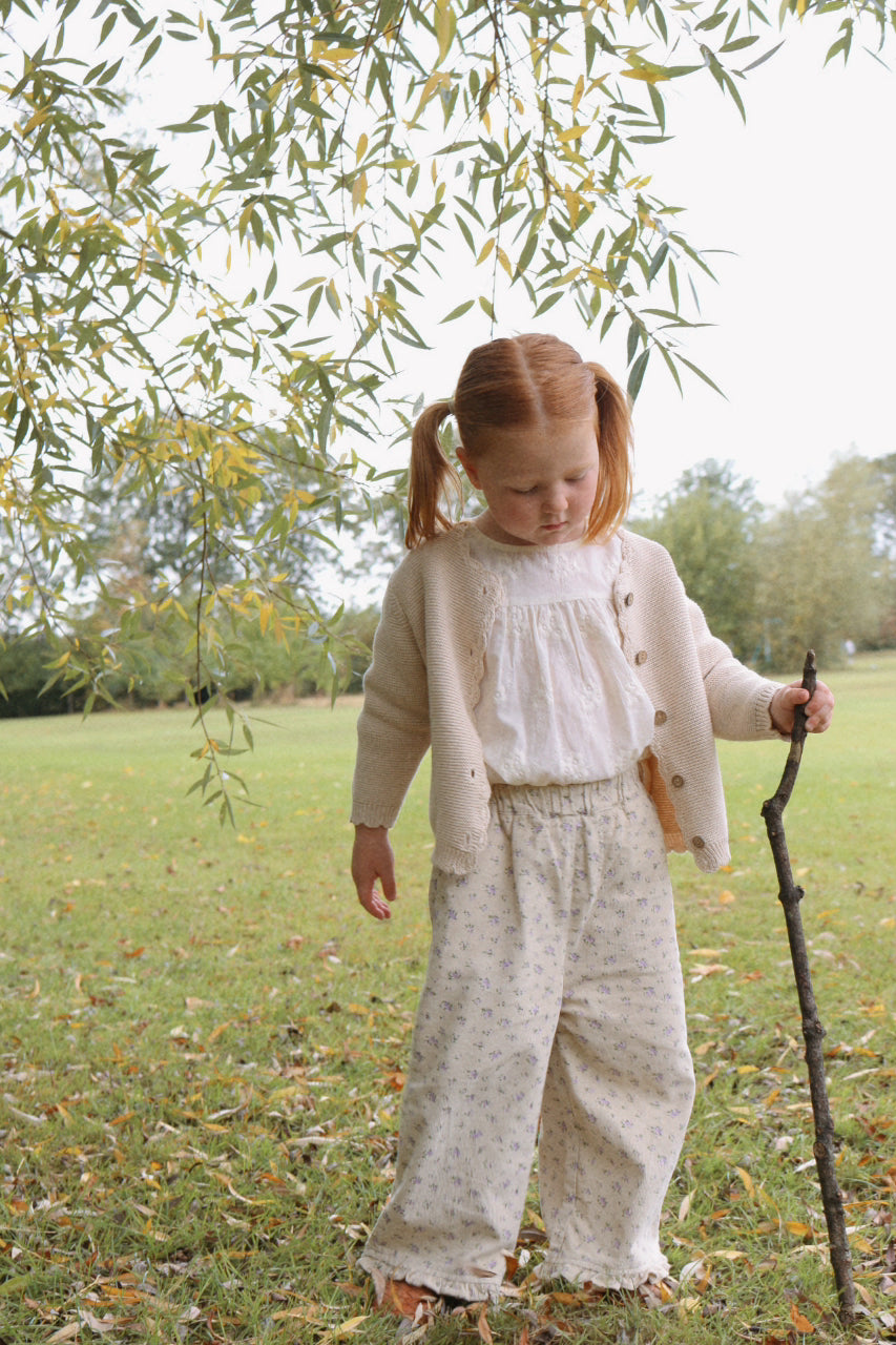 Young girl in a natural setting with trees and grass