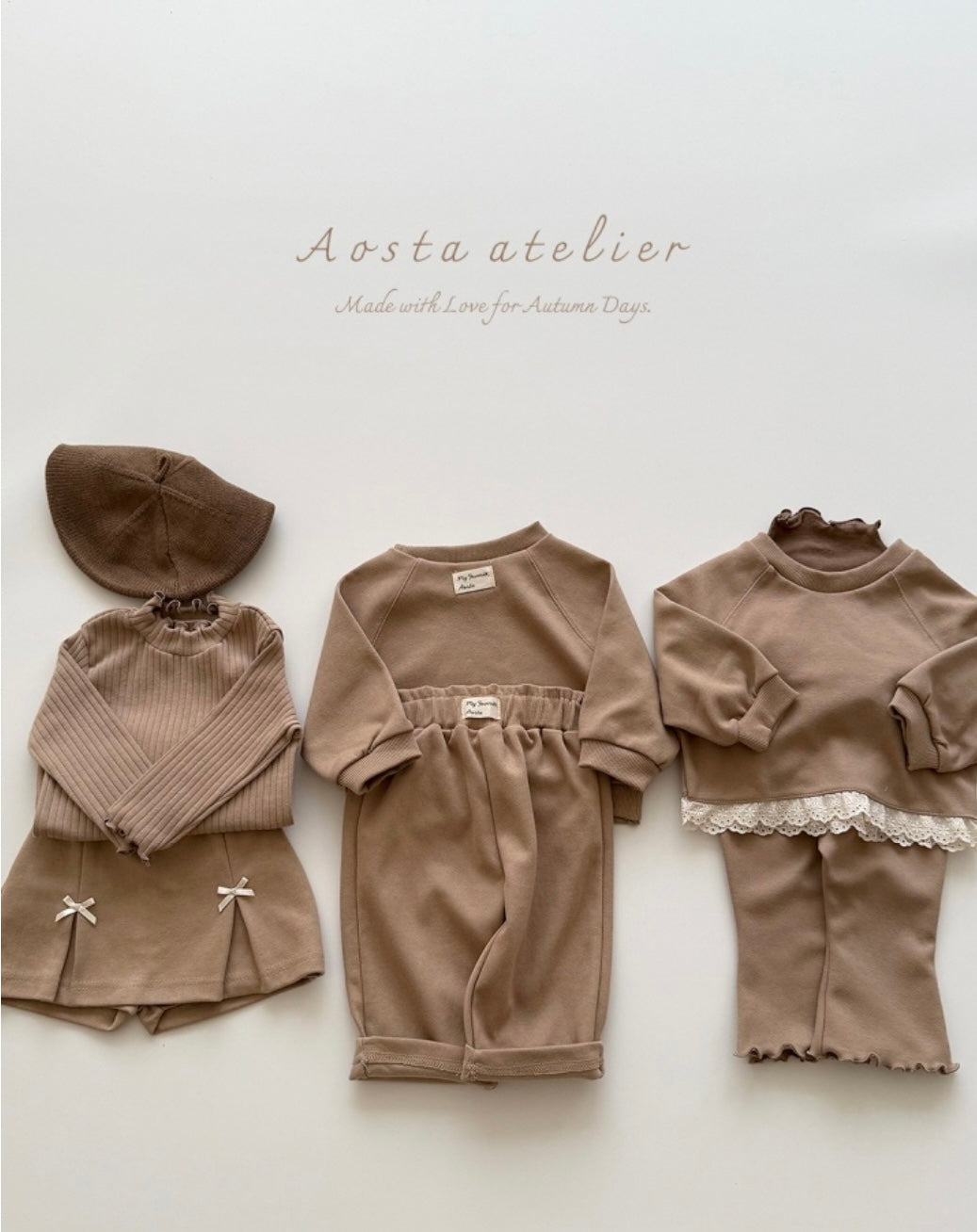 Children's brown outfit set with matching hat on a light background, featuring the brand 'Aosta atelier'.