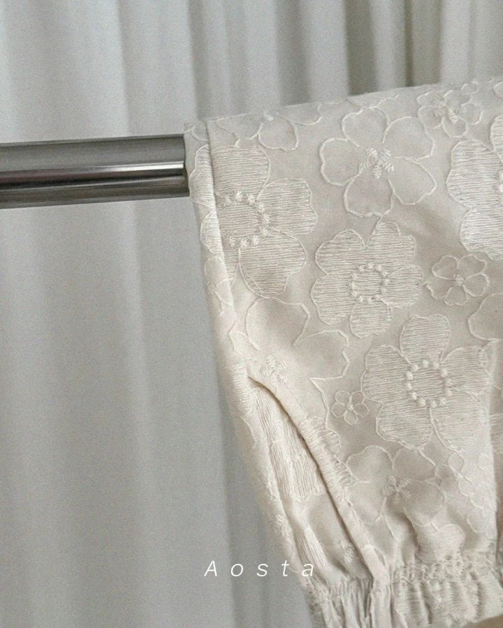 Girls Pants with floral lace detail and a metal rod, branded 'Aosta'.