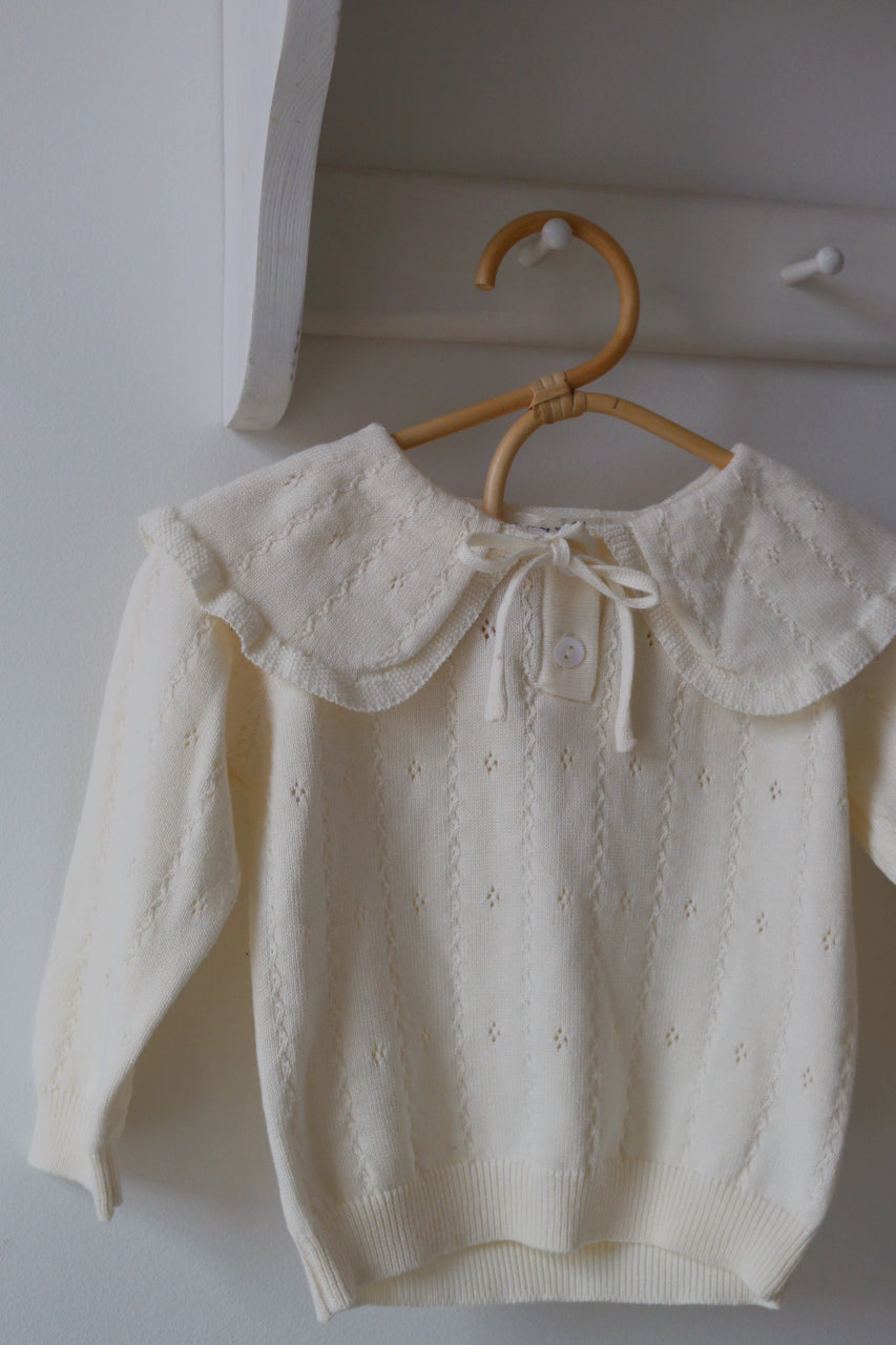 Ivory Pointelle Jumper hung ona bamboo coat hangers