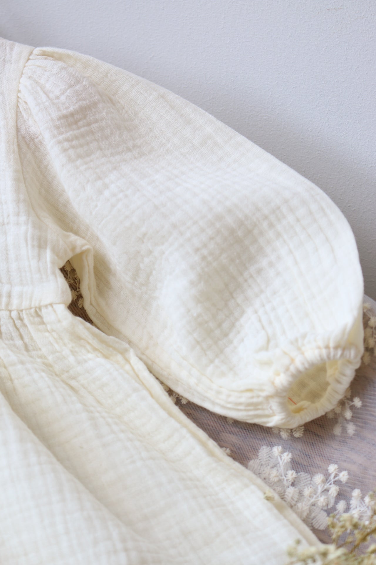 Close-up of a white textured fabric on a light gray background