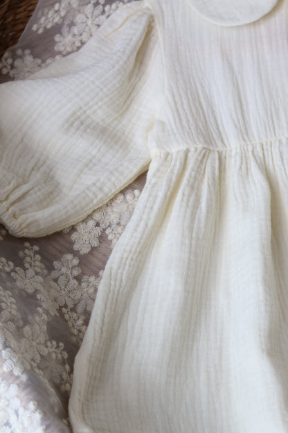 Close-up of a cream dress laid on lace detailing