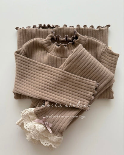Brown ribbed turtleneck sweater with lace details on a white background, branded 'Aosta atelier'.