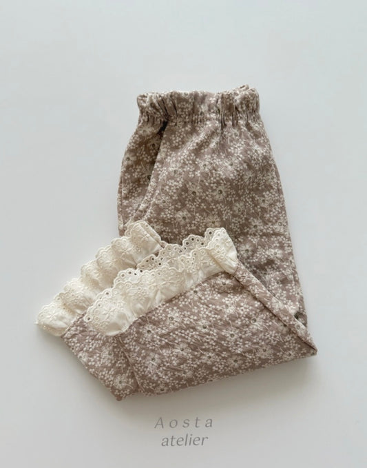 Floral-patterned fabric with lace trim on a light gray background, featuring the brand 'Aosta atelier'.