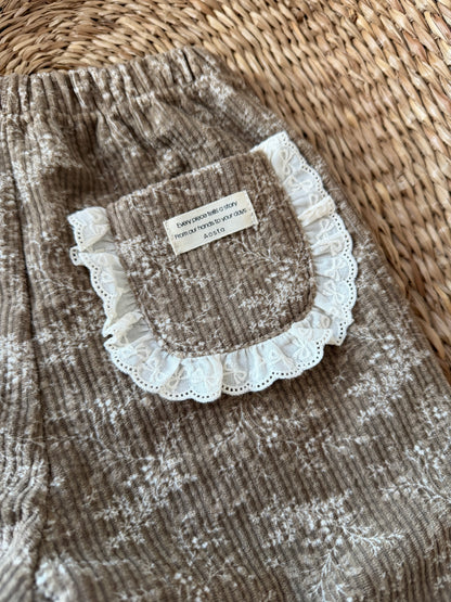 BROWN FLORAL CORDUROY TROUSERS WITH BRODERIE FRILL