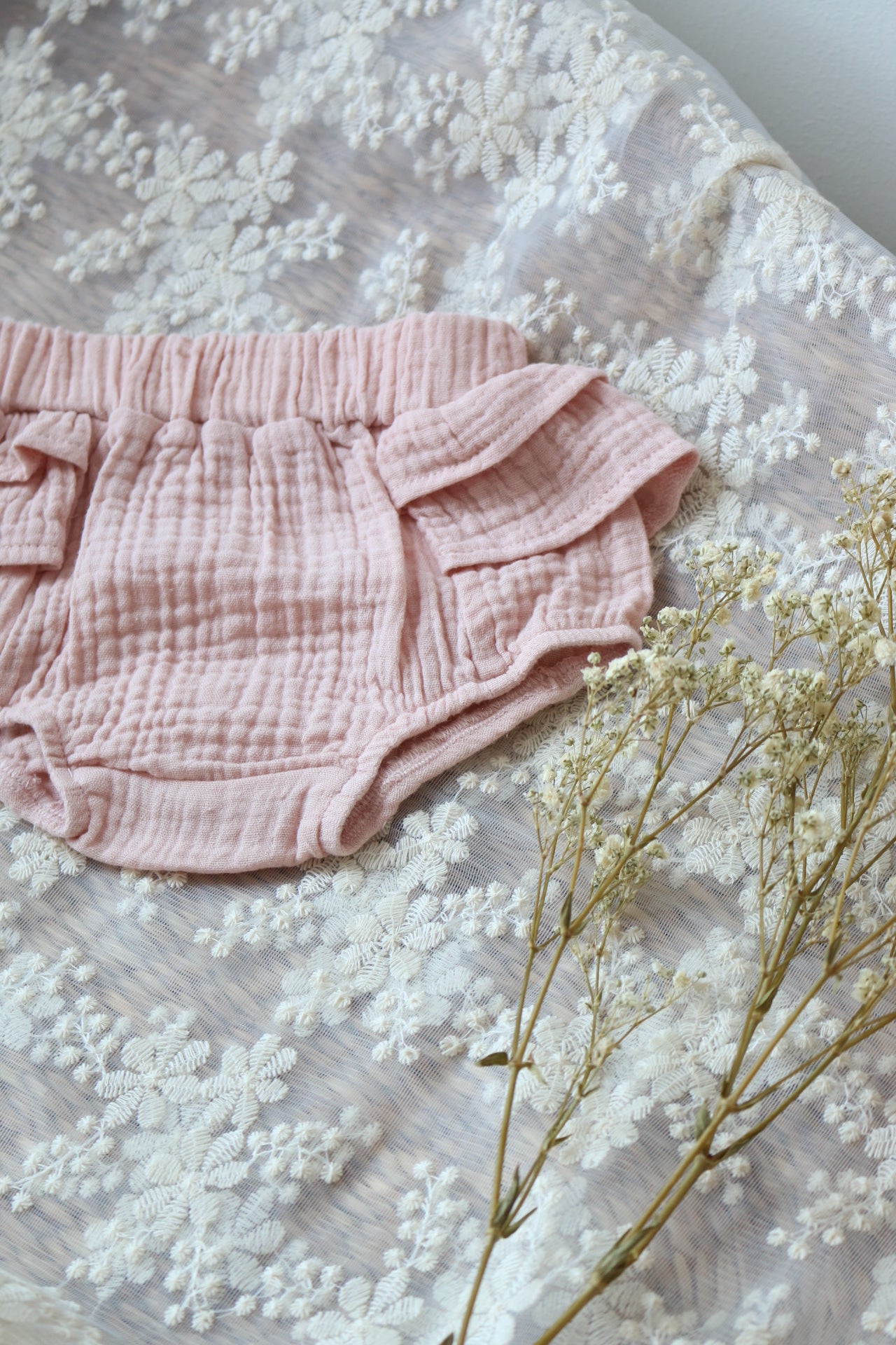 rose muslin bloomers laid on lace fabric