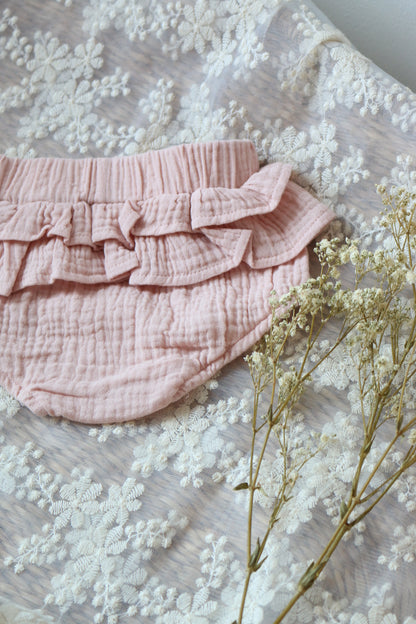 rose coloured cotton bloomers laid on lace with flowers