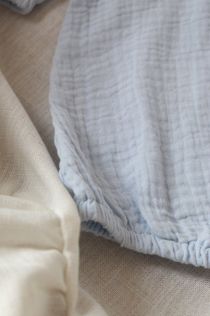 Close-up of a blue romper on a textured surface