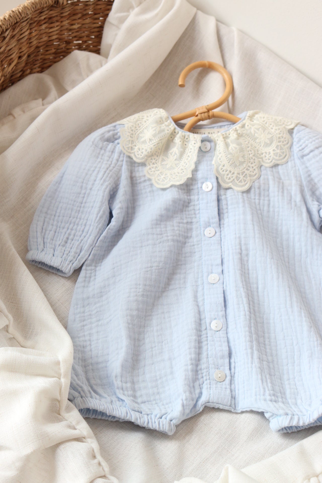 Light blue baby outfit on a neutral background