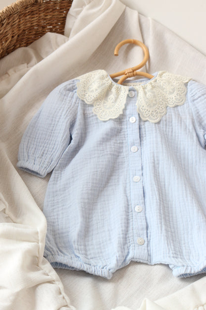 Light blue baby outfit on a neutral background